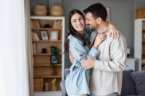 istock Couple Joyfully Embracing in a Stylish Home Interior 2242475948