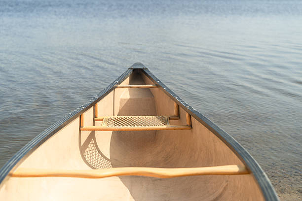 istock Close-up of canoe bow on calm lake with transparent rippling water. 2242482607