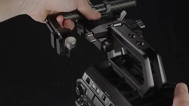 istock A person carefully adjusts the robust camera rig system for optimal. 2242486181