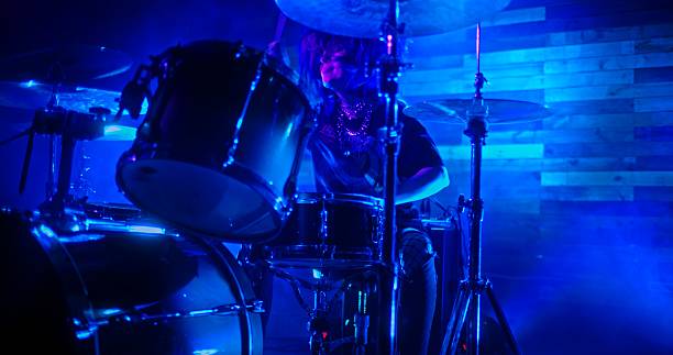 istock Professional Drummer emphatically playing the drums in twinkling strobe lights 2242488408