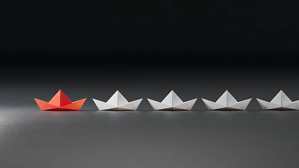 istock Different business concept.new ideas. paper art style. creative idea.Leadership concept, red leader boat leading white boats.3D rendering on black background. 2242488433