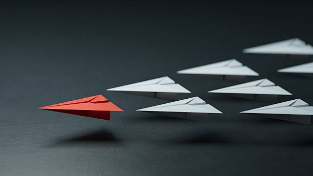 istock Different business concept.new ideas. paper art style. creative idea.Leaderplane concept with red paper plane leading among white.3D rendering on black background. 2242488437