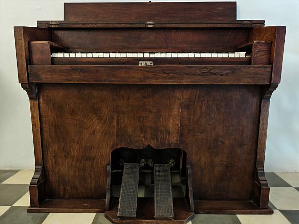 istock vintage oak upright with brass pedals, solid oak upright piano featuring rich grain and brass pedals 2242488658
