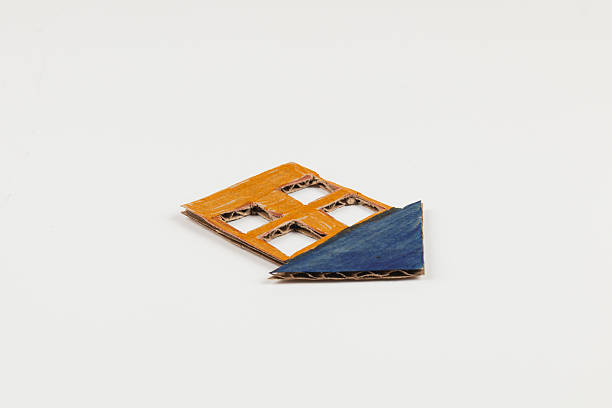 A handcrafted cardboard art piece features a vibrant orange and blue geometric design. It is a creative representation of shapes displayed on a white surface.