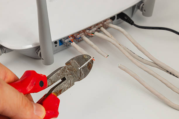 istock Cutting wires for network connection in a home office setup 2242489482