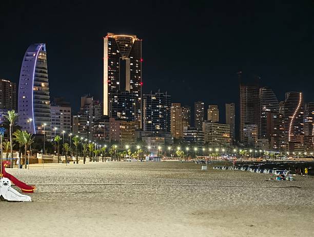istock empty playground slide on sandy promenade with illuminated towers palm trees 2242492107