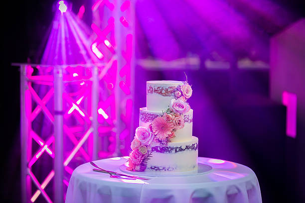 istock Beautiful white wedding cake decorated with flowers close up 2242492552