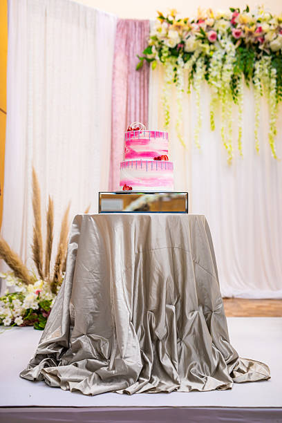 Beautiful pink wedding cake decorated with strawberries close up