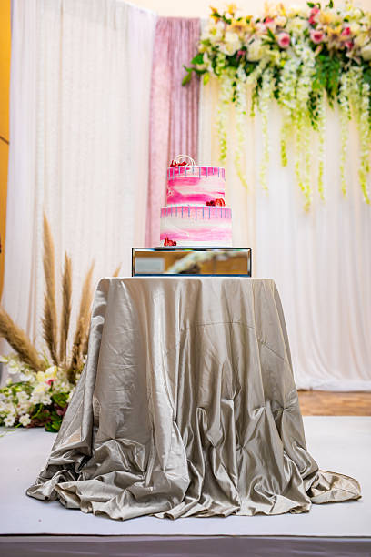 Beautiful pink wedding cake decorated with strawberries close up