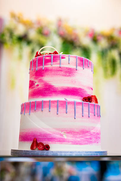Beautiful pink wedding cake decorated with strawberries close up