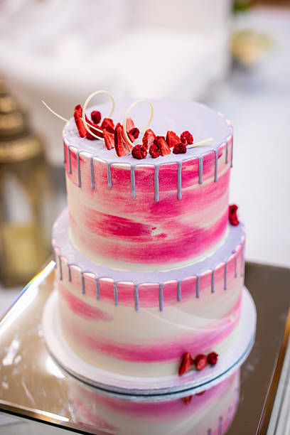 Beautiful pink wedding cake decorated with strawberries close up