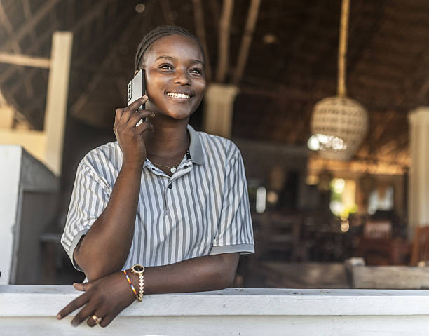 istock African woman connecting online trought smartphone  and computer 2242495417