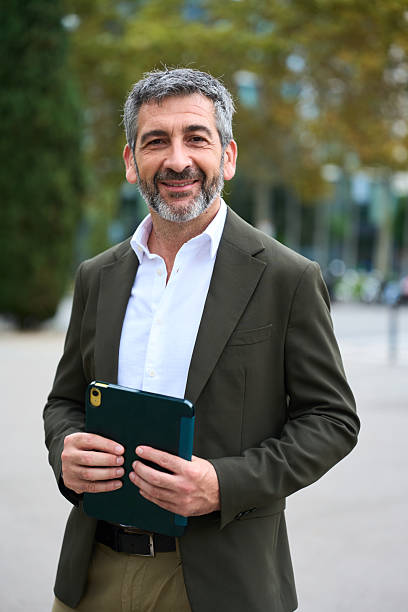 istock Confident businessman standing outdoors holding a tablet 2242499166