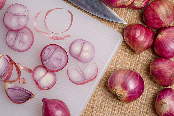 istock Top view shallot or onion and knife put on the cutting board 2242500741
