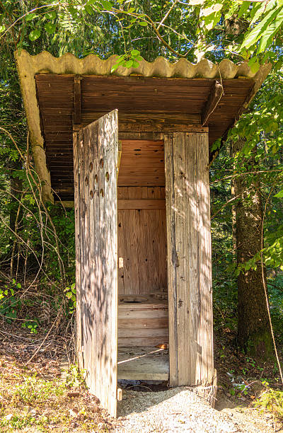 istock Rustic Wooden Outhouse in Forest 2242507610