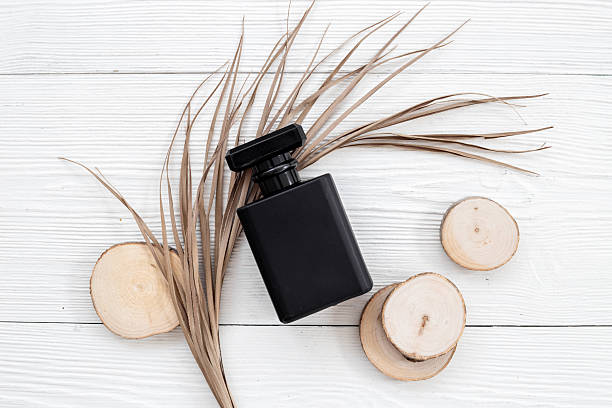 istock Black matte perfume bottle with ingredients . Top view. 2242507706