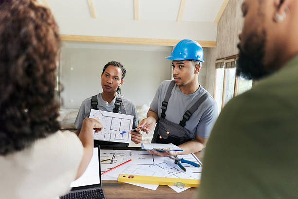 istock Manual workers talking to their customers about housing plans. 2242509784