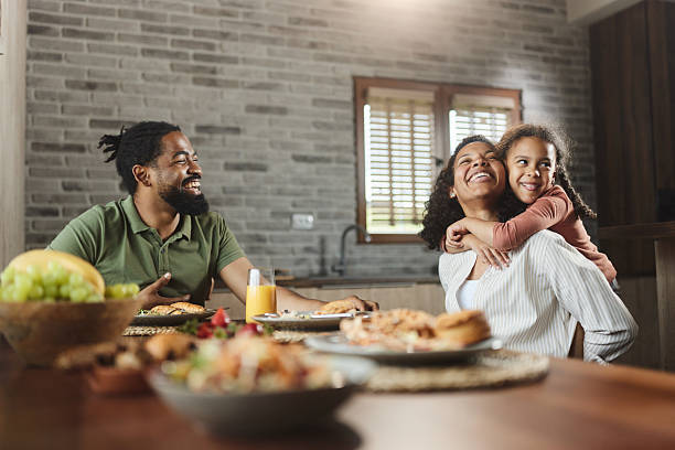 istock Cheerful black family having fun during breakfast at dining table. 2242510810