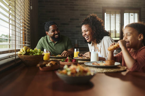 istock Cheerful black family having fun during a meal at dining table. 2242510908