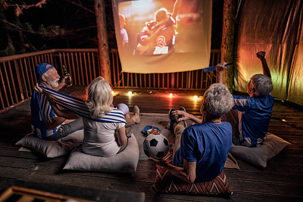 istock Watching soccer match on projection screen at night! 2242512015