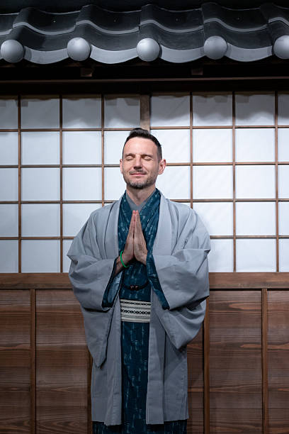 istock Samurai Meditation Pose in Traditional Gray Blue Robe 2242513646