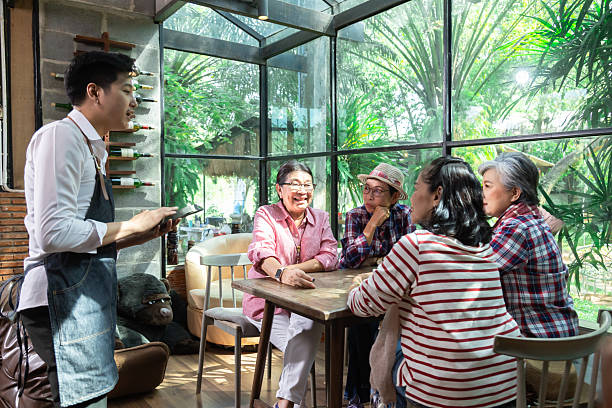 istock Restaurant eatery shop, Asian senior women having fun searching menus from tablet computer learning to order food by modern application, elderly pension females happy friendly with wireless technology 2242514502