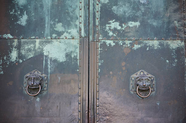 Turquoise and dark gray textured metal surface background, part of an old church door.