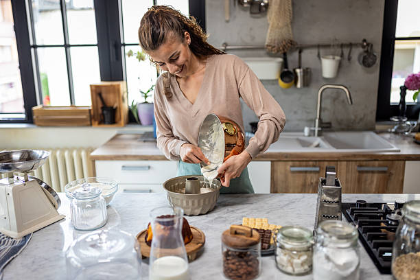 istock Woman Baking In Modern Kitchen Pouring Batter Into Pan For Fresh Chocolate Cake 2242518134