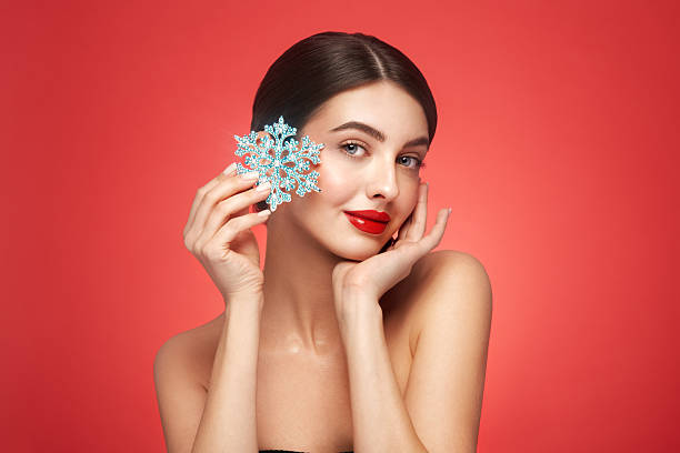 istock Beautiful young woman with glowing snowflake 2242519947
