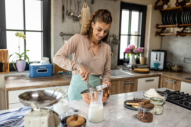 istock Home Kitchen: Woman Mixing Batter in Modern Cozy Kitchen for Fresh Bakery Atmosphere 2242521512