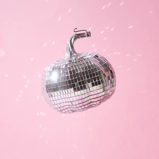 istock Disco ball pumpkin minimal concept on a pastel pink backround.Halloween party 2242522839