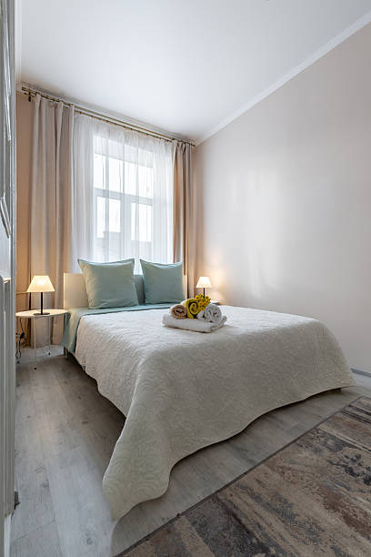 istock Bright Cozy Bedroom with Soft Lighting and Fresh Towels 2242523688