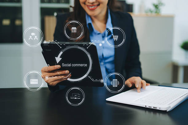istock Female hand using smart phone and tablet with social commerce icon on virtual screen e-commerce and social media 2242523902