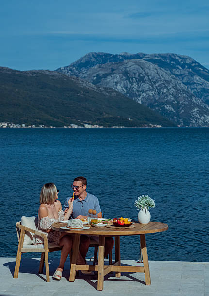 istock Young Couple Enjoying Seaside Brunch on Holiday 2242525177