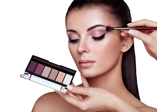 istock Makeup artist applies eye shadow 2242525228