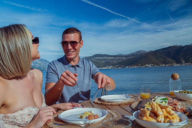 istock Young Couple Enjoying Seaside Brunch on Holiday 2242525431