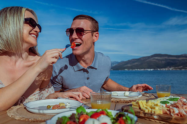 istock Young Couple Enjoying Seaside Brunch on Holiday 2242525452