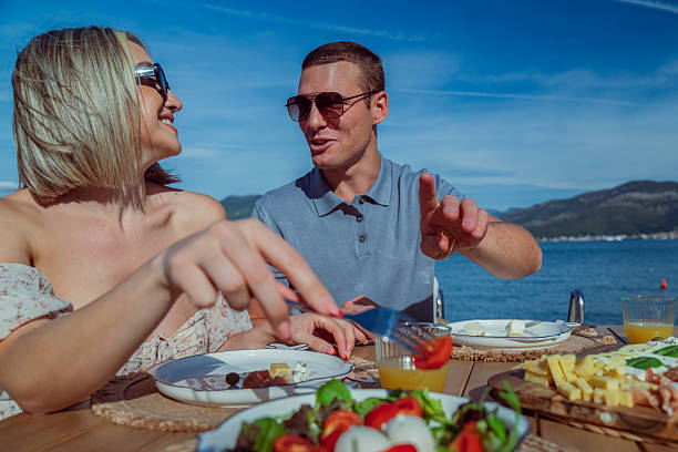 istock Young Couple Enjoying Seaside Brunch on Holiday 2242525453