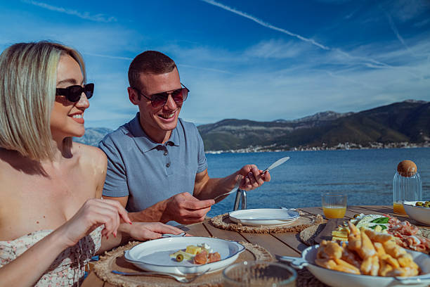 istock Young Couple Enjoying Seaside Brunch on Holiday 2242525456