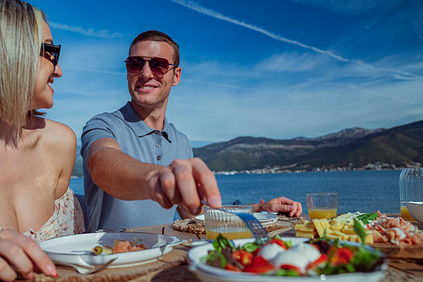 istock Young Couple Enjoying Seaside Brunch on Holiday 2242525463