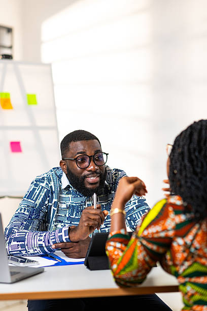 istock Two African professionals engaging in a lively discussion at a modern office, exuding collaboration and positive energy 2242525758