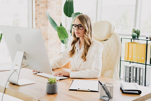 istock Elegant businesswoman working at a desk in a modern office setting with a computer and professional demeanor 2242528084
