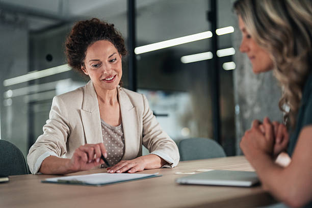 istock Professional discussion between advisor and client and successful signing of contract 2242528204