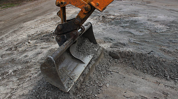 istock Beginning work on digging a wide trench using an excavator with a special toothed ladle 2242528861