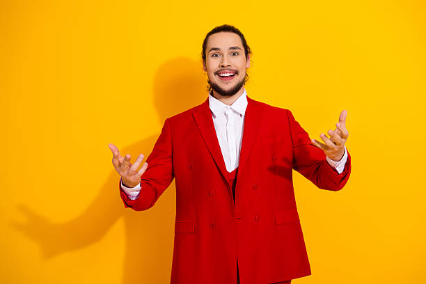 istock Funny showman in a bold red suit beams with charm as a bright yellow backdrop elevates celebration vibes 2242531633