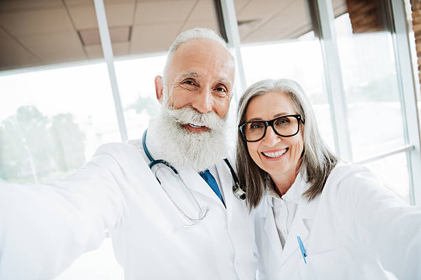 istock Friendly doctors in white coats share a warm selfie in a bright clinic showing teamwork care and healthy living for patients and families in a modern hospital 2242531991