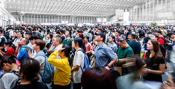 istock Large group of passengers waiting for a train at train station 2242533045