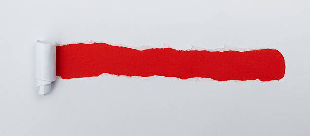 istock Tear open the white paper on the red paper 2242533251
