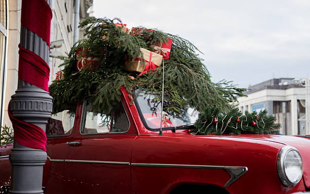 istock Vintage red car with christmas tree 2242534433