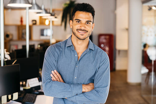 istock Confident businessman standing with arms crossed in office 2242538524
